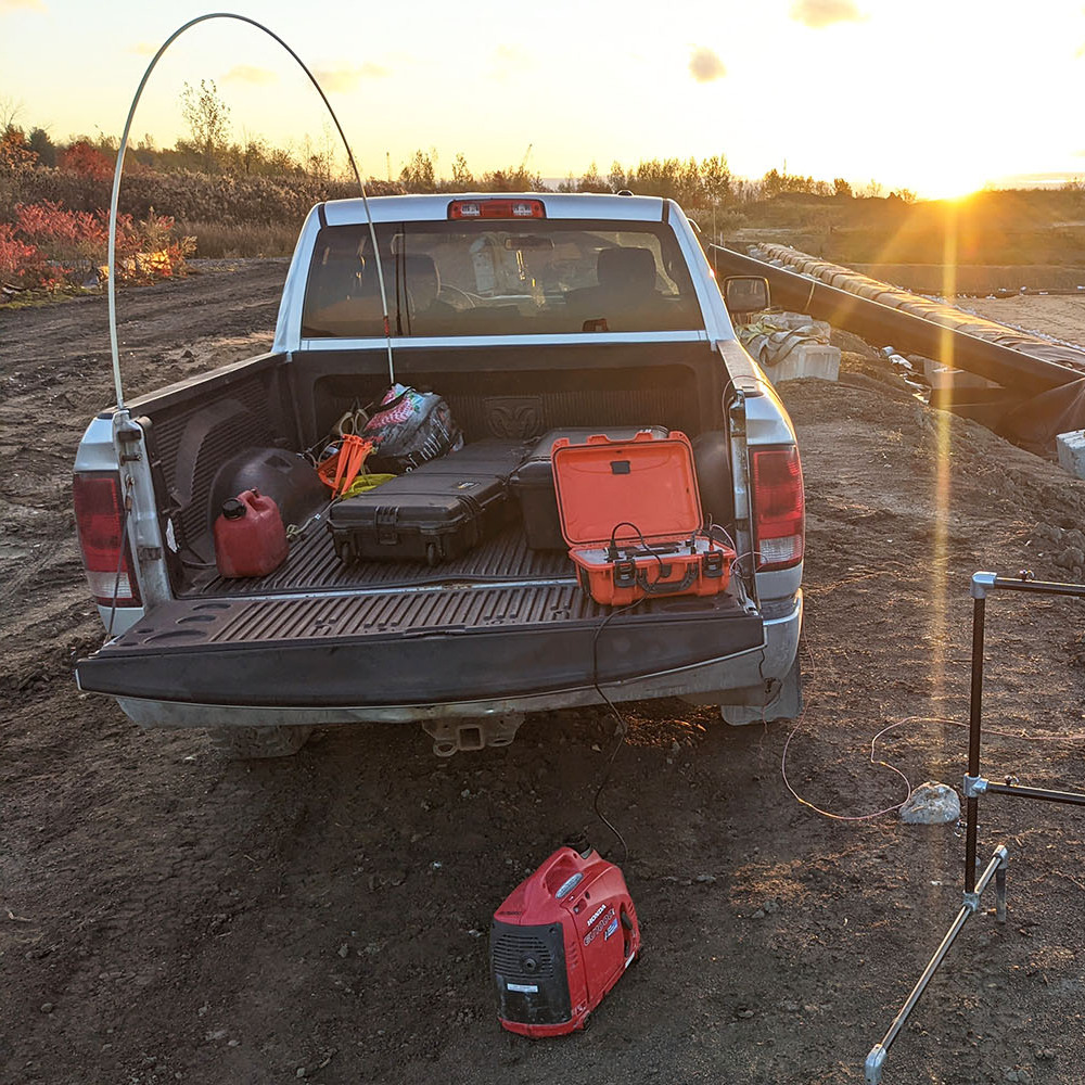 Men on a geomembrane doing leak location at the Laronde mine